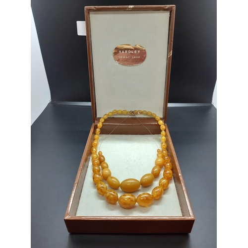 56 - Two vintage amber effect necklaces