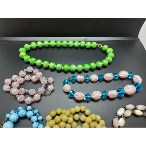 59 - A collection of mid 20th century necklaces to include ceramic, vaseline glass and mother of pearl