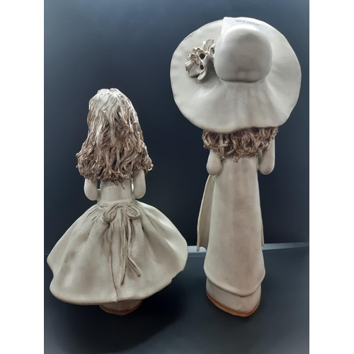 99 - Two Veronica Ballan faceless lady stoneware figurines