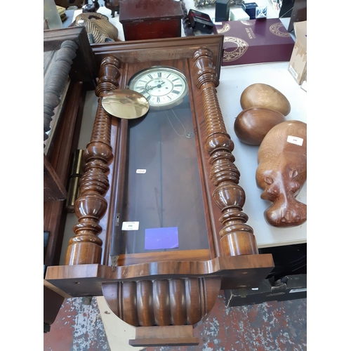 250 - A Victorian walnut cased chiming Vienna wall clock with cream enamel face, Roman numerals, pendulum ... 