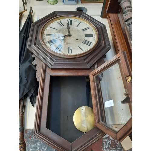 252 - An American Ansonia Clock Company of New York oak cased 8 day wall clock with Roman numerals, pendul... 