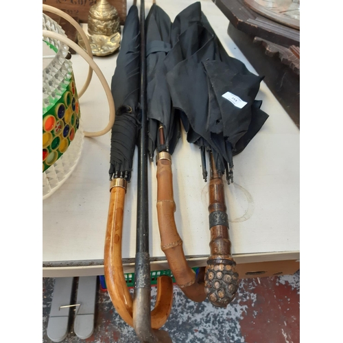 253 - Four items to include a vintage umbrella with hallmarked 12ct gold collar and labelled 'Peerless', v... 