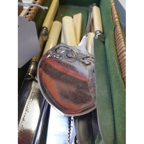 258 - A basket containing various antique and vintage cutlery