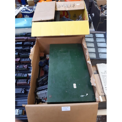 268A - Two boxes containing model railway accessories to include locomotives, carriages, wagons, track etc.... 