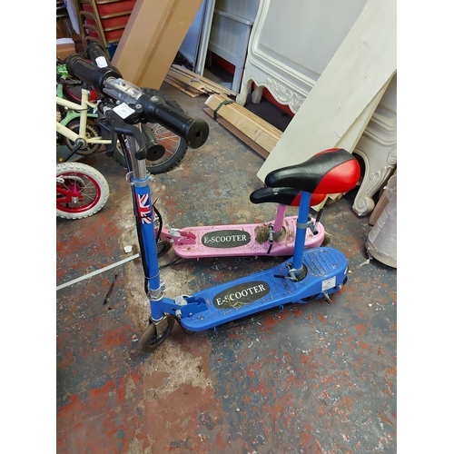 1007 - Two E-Scooter electric ride ons, one pink, one blue