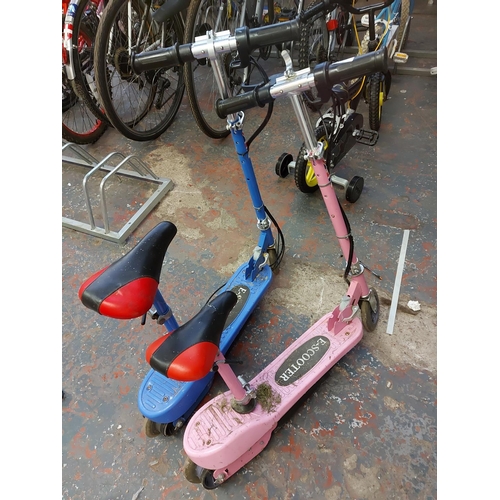 1007 - Two E-Scooter electric ride ons, one pink, one blue