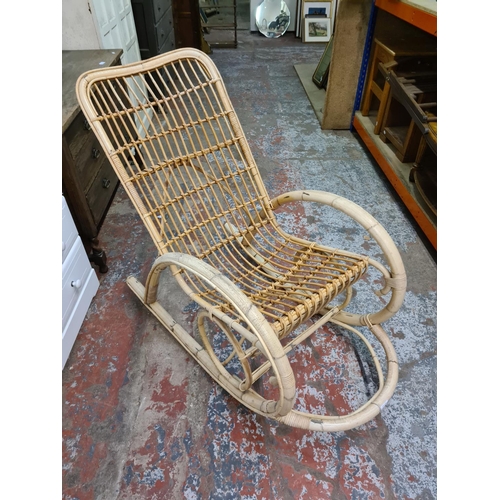 384 - A mid 20th century bamboo and wicker rocking chair