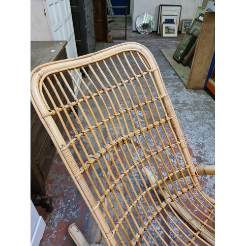 384 - A mid 20th century bamboo and wicker rocking chair