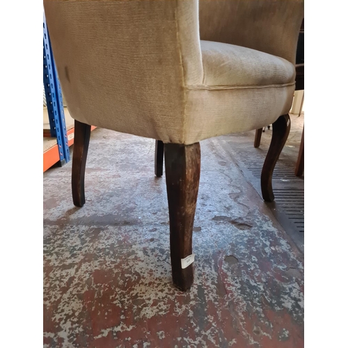 403 - An Edwardian oak tub chair on cabriole supports with brown upholstery