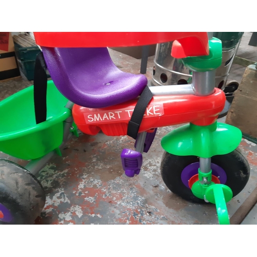 1011 - A multicoloured Smart Trike child's tricycle with safety handle