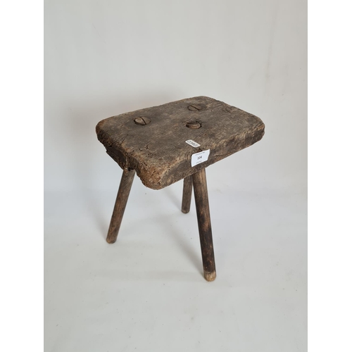 104 - A primitive elm tri-legged milking stool - approx. 34cm high