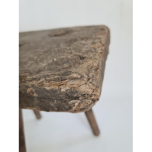 104 - A primitive elm tri-legged milking stool - approx. 34cm high