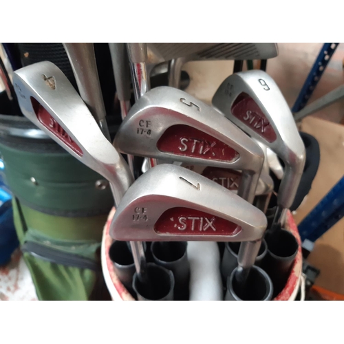 1066 - Three golf bags containing Dunlop, Slazenger, Hippo and Stix clubs