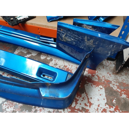 1069 - A rare Ford Escort MKIII two door body kit in metallic blue comprising front and rear bumpers, front... 