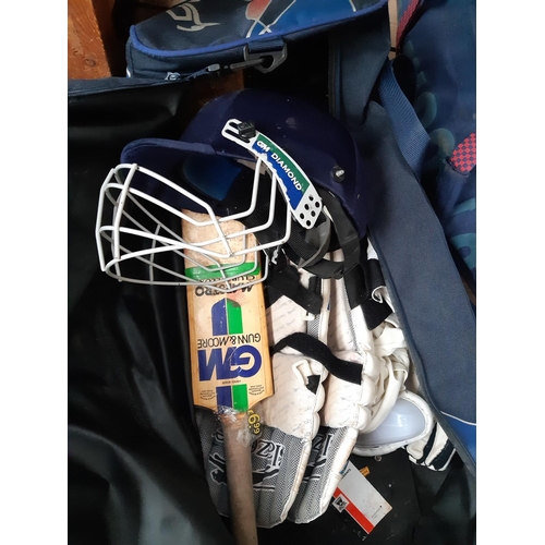 1112 - Three bags of Cricket equipment to include Slazenger stumps and bat, GM helmet and bat, gloves, pads... 