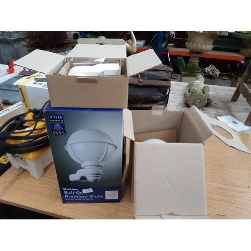 1121 - A boxed Wickes Exit-On premium globe exterior light with PIR motion detector