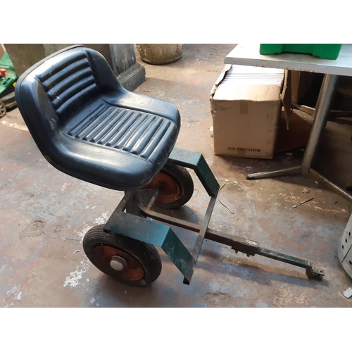 1131 - A green lawnmower trailer seat