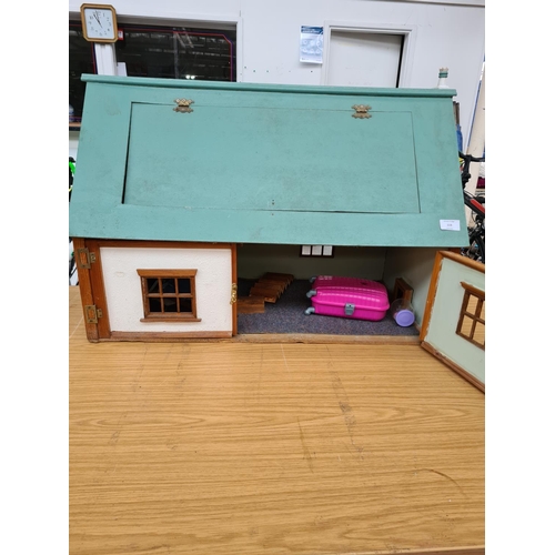 119 - A wooden dolls house with contents