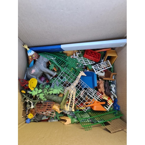 129 - A box containing a large quantity of various toys to include plastic animals, diecast vehicles, Lego... 