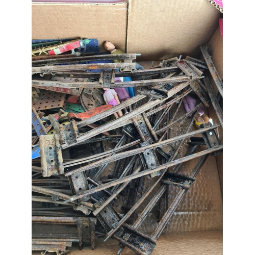 133 - A box containing Meccano and tin plated model railway accessories to include track, tankers, locomot... 