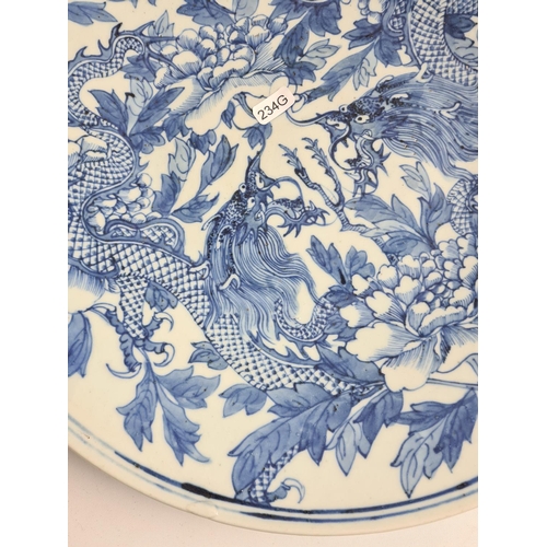 153 - A late 19th/early 20th century Chinese blue and white porcelain wall charger with dragon design - ap... 