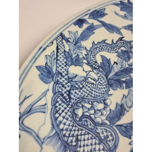 153 - A late 19th/early 20th century Chinese blue and white porcelain wall charger with dragon design - ap... 