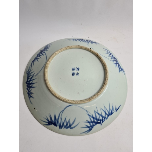 153 - A late 19th/early 20th century Chinese blue and white porcelain wall charger with dragon design - ap... 