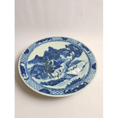 154 - A late 19th/early 20th century Chinese blue and white porcelain charger with mountain scene design -... 