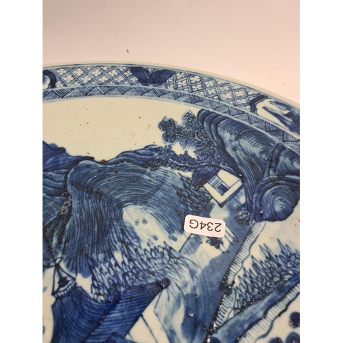 154 - A late 19th/early 20th century Chinese blue and white porcelain charger with mountain scene design -... 