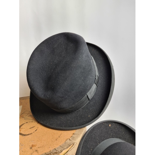 185 - Three vintage hats, a Dunn & Co. of London black bowler hat, Austin Reed Ltd. black bowler hat and a... 