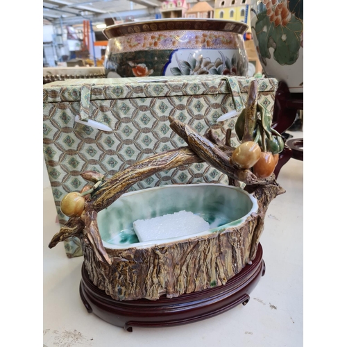 202 - Three oriental items to include a cased ceramic tree trunk handled basket with stand and two porcela... 