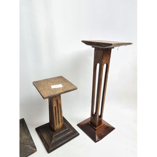 217 - Four items to include three vintage oak candle stands and one vintage table lamp base