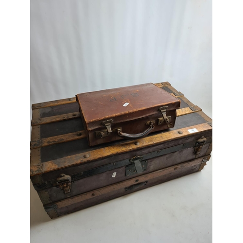 243 - Two items, a small vintage brown leather travel case and a large vintage oak banded travel trunk