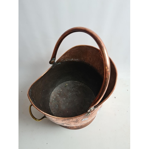 245 - A Victorian hammered copper helmet coal scuttle