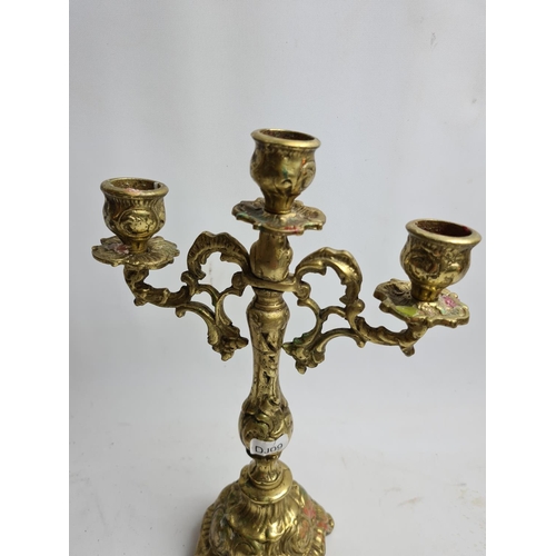 251 - Two items to include a brass three branch candelabra and a wooden religious cross