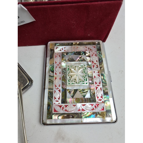 255 - A box containing various items to include a pair of hallmarked Sheffield silver sugar tongs - approx... 