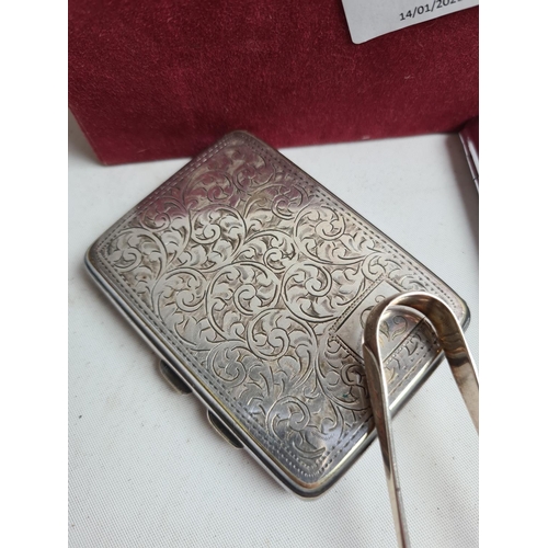 255 - A box containing various items to include a pair of hallmarked Sheffield silver sugar tongs - approx... 