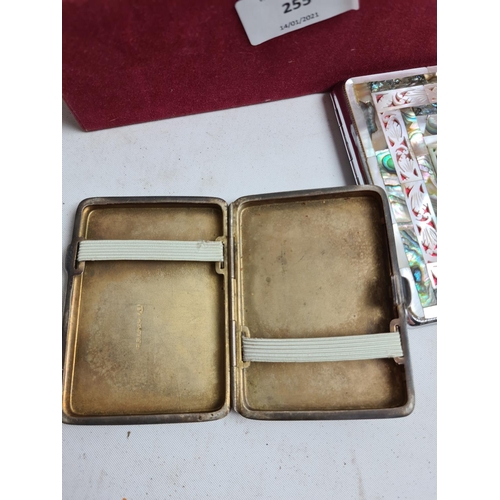 255 - A box containing various items to include a pair of hallmarked Sheffield silver sugar tongs - approx... 