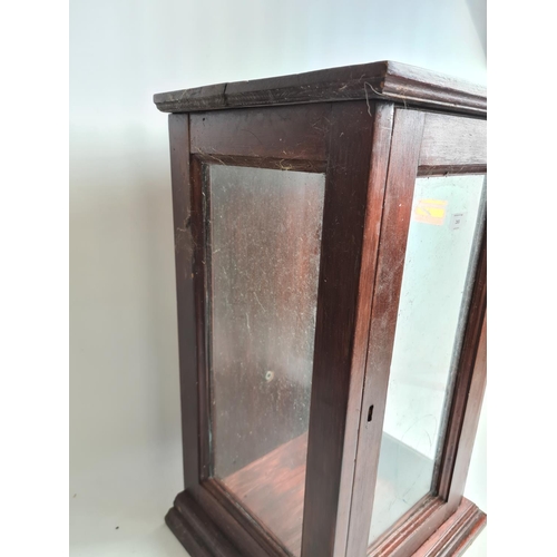 265 - A mid 20th century stained oak shop display cabinet