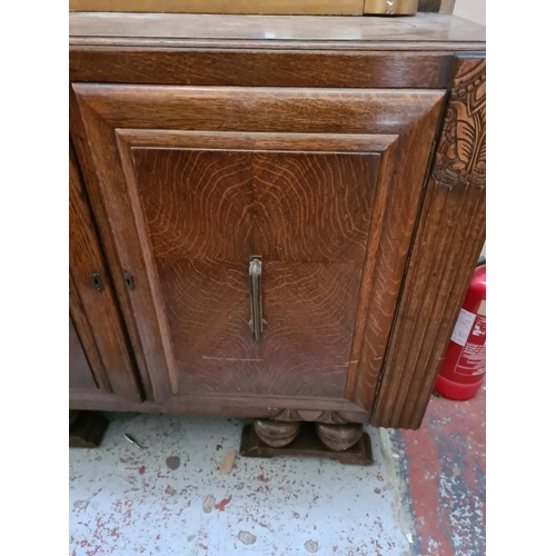 272 - An Art Deco oak sideboard - approx. 122cm wide x 46cm deep x 100cm high