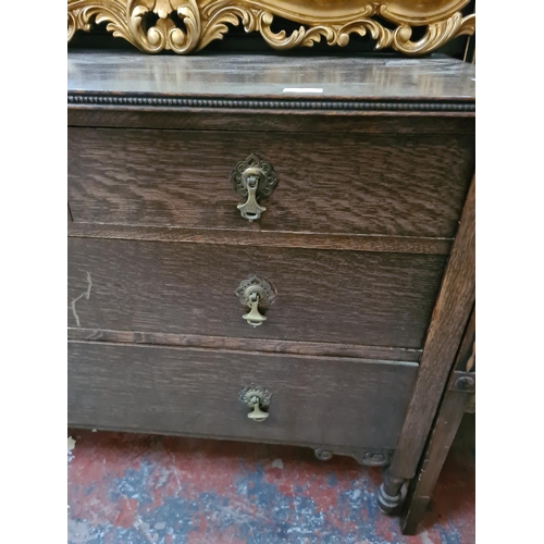 282 - An oak chest of two short over two long drawers on casters - approx. 107cm wide x 80cm high x 50cm d... 