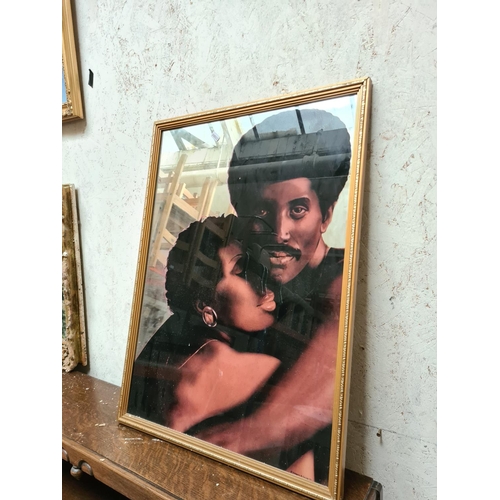 284a - A gilt framed loving couple mirror - approx. 54cm x 75cm