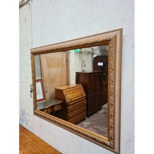 290 - A large gilt framed wall mirror - approx. 121cm x 91cm