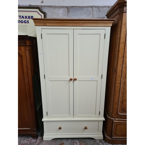 303 - A modern oak and cream painted double wardrobe - approx. 193cm high x 100cm wide x 63cm deep