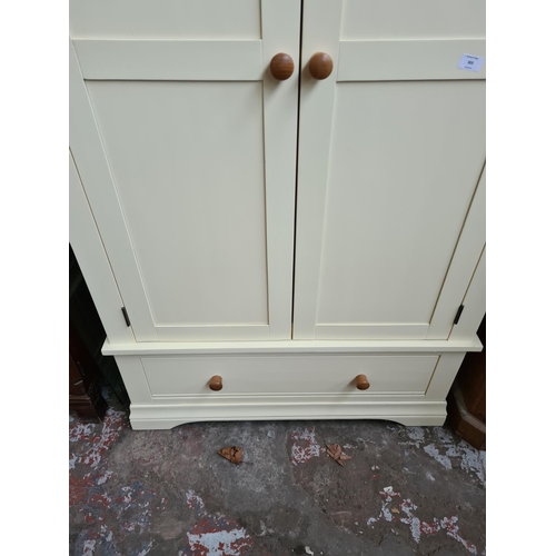 303 - A modern oak and cream painted double wardrobe - approx. 193cm high x 100cm wide x 63cm deep