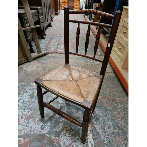 312 - Two 19th century elm farmhouse chairs with rush seats to include one rocking chair