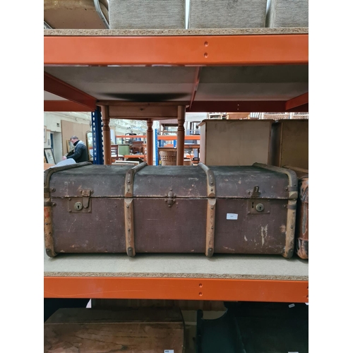 323 - A vintage brown canvas and oak banded travel trunk