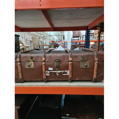 324 - A vintage brown canvas and oak banded travel trunk