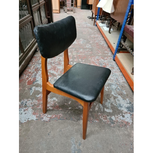 340 - A set of four mid 20th century style black leatherette dining chairs