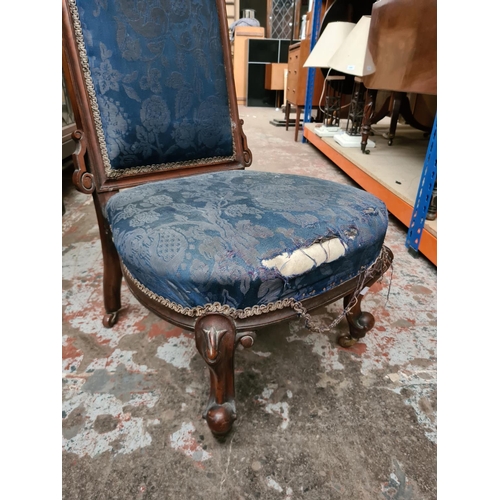 341 - A Victorian mahogany and blue upholstered nursing chair on casters